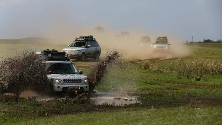 Range Rover vehicles driving in mud